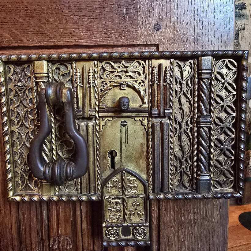 A carved wooden door and its iron knocker at Hever Castle