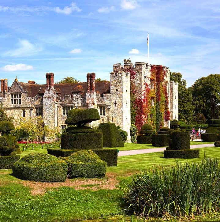 Hever Castle behind the clipped topiary of the garden, with autumn colour on the walls