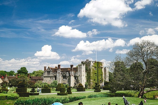 Hever Castle seen from the topiary lawn, with clipped yew shapes in the foreground