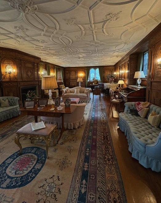 A panelled room inside Hever Castle, furnished under its moulded plaster ceiling