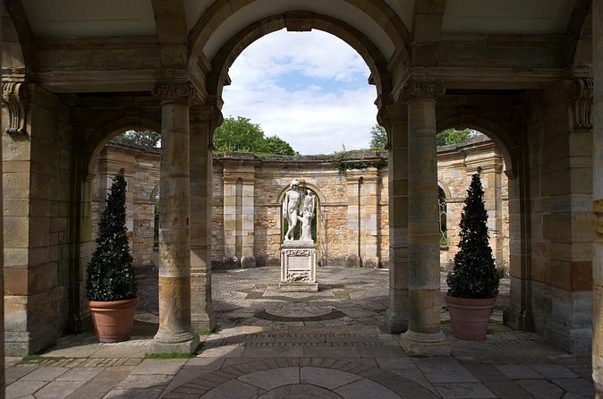 Classical statuary framed by the colonnade in Hever Castle's Italian Garden